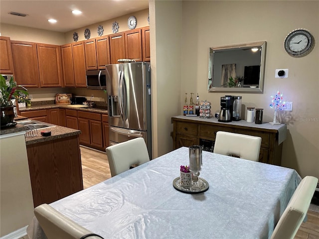 kitchen featuring light hardwood / wood-style floors, sink, and appliances with stainless steel finishes