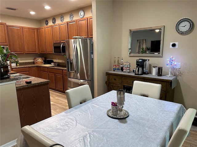 2271 50th Street Cir E, Palmetto, FL 34221 - kitchen featuring appliances with stainless steel finishes, light wood-style floors, brown cabinets, and recessed lighting