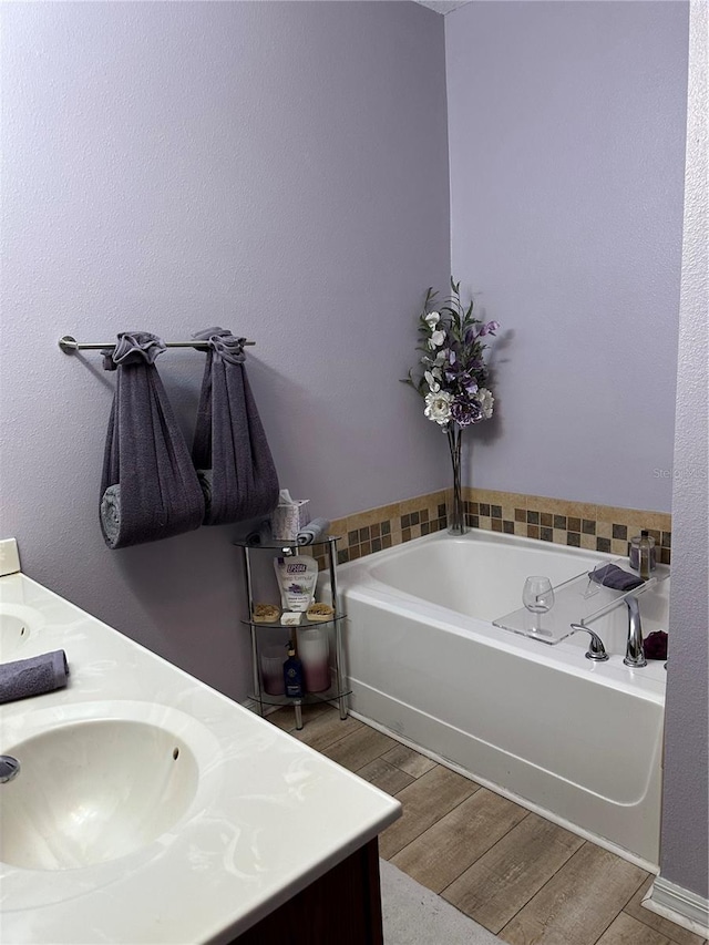 2271 50th Street Cir E, Palmetto, FL 34221 - bathroom featuring wood finished floors, double vanity, and a bath