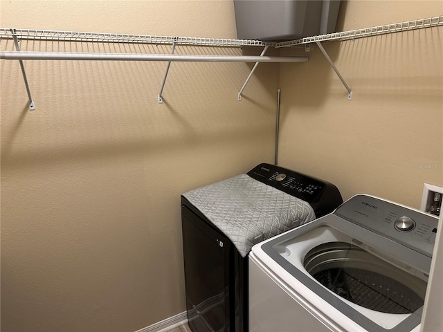 laundry area featuring washing machine and clothes dryer