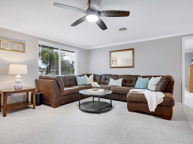 living room featuring ornamental molding, light carpet, and ceiling fan