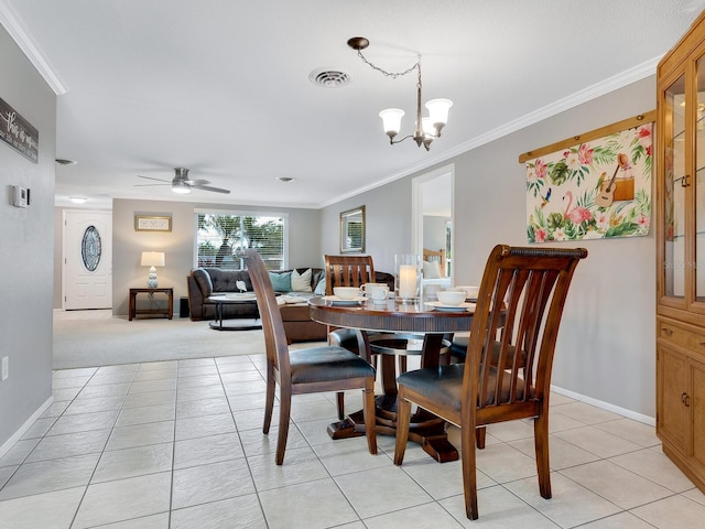 tiled dining area with ceiling fan with notable chandelier and ornamental molding