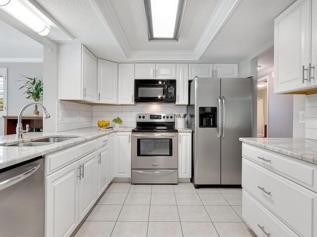 kitchen featuring white cabinetry, sink, crown molding, and stainless steel appliances