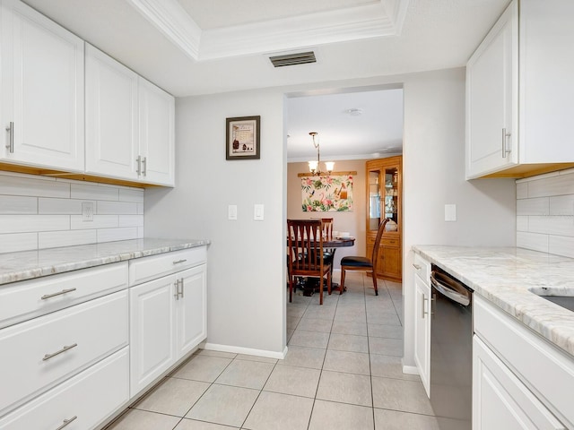 kitchen featuring stainless steel dishwasher, white cabinets, crown molding, and tasteful backsplash