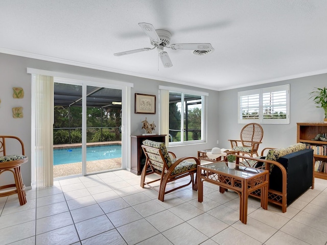 living area with light tile patterned flooring, ceiling fan, and crown molding