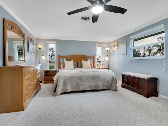 bedroom featuring multiple windows, light carpet, ceiling fan, and crown molding