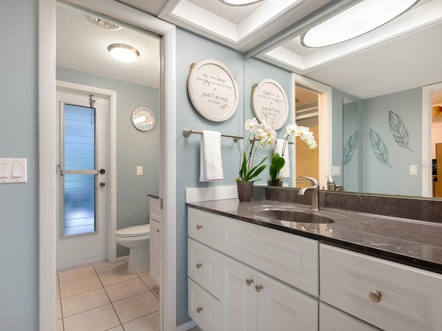 bathroom with vanity, tile patterned flooring, and toilet