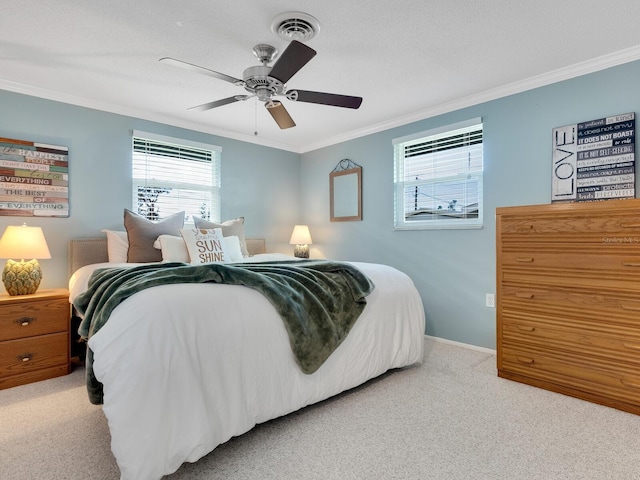 carpeted bedroom featuring ceiling fan and crown molding