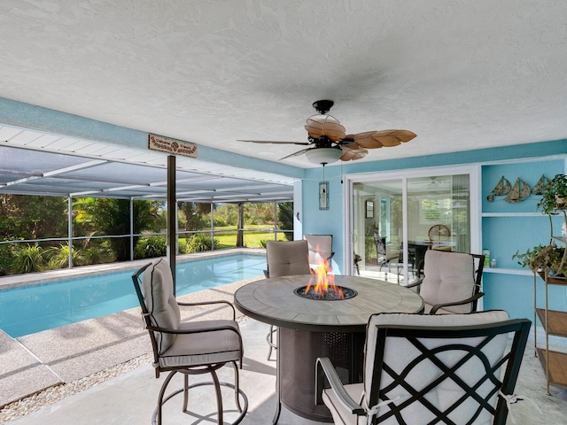 view of swimming pool featuring ceiling fan and a patio area