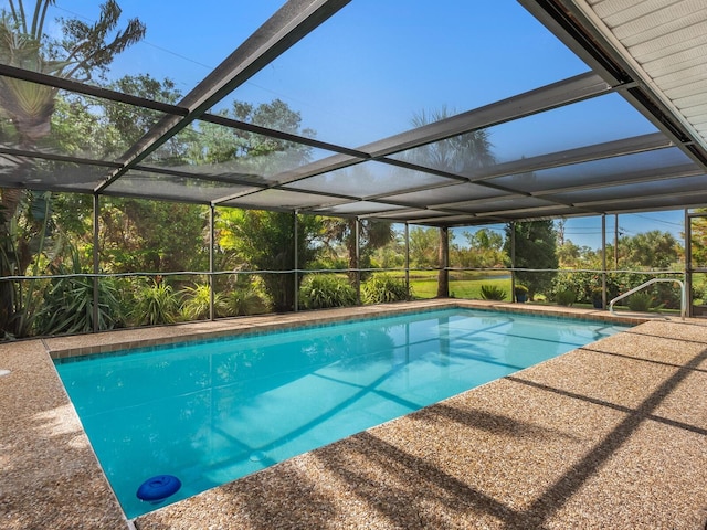 view of pool with glass enclosure