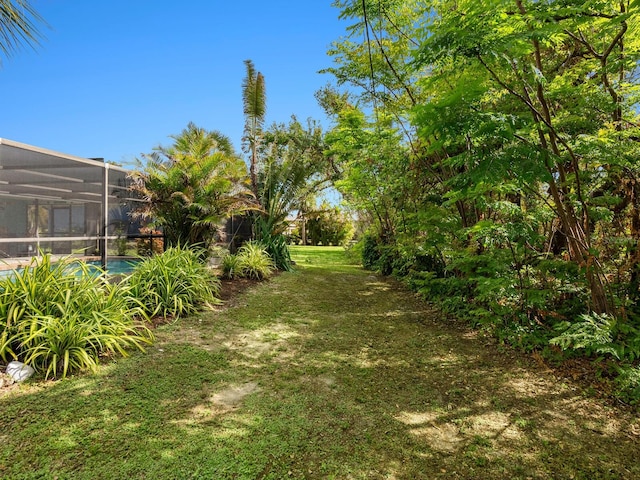 view of yard featuring a lanai