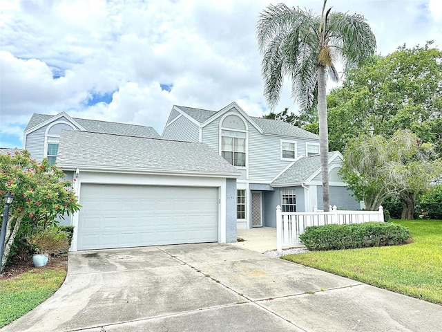 view of front facade with a garage and a front lawn