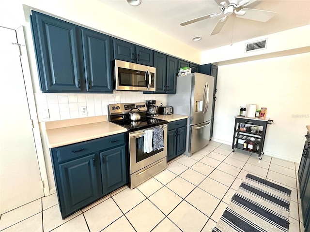 kitchen with stainless steel appliances, backsplash, light countertops, and visible vents