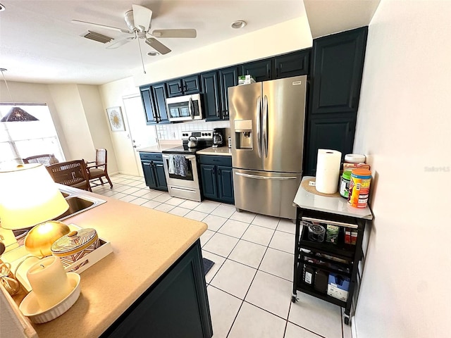 kitchen with stainless steel appliances, light countertops, visible vents, and light tile patterned floors