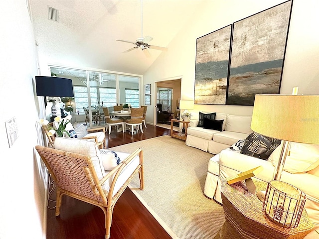 living room with high vaulted ceiling, wood finished floors, visible vents, and a ceiling fan