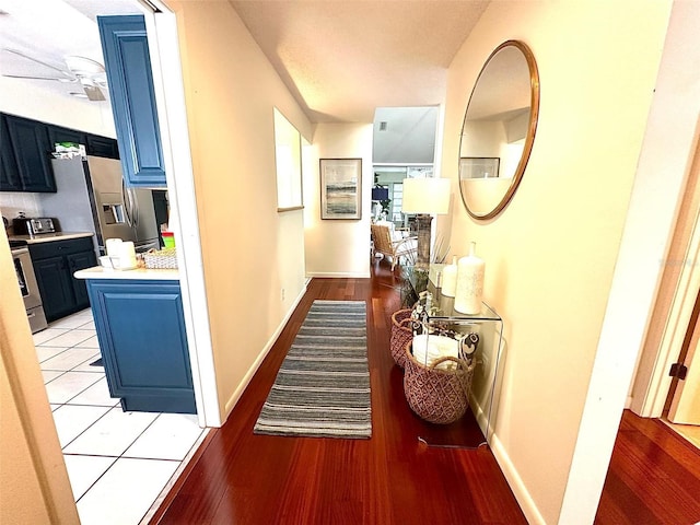 hallway with light wood finished floors and baseboards