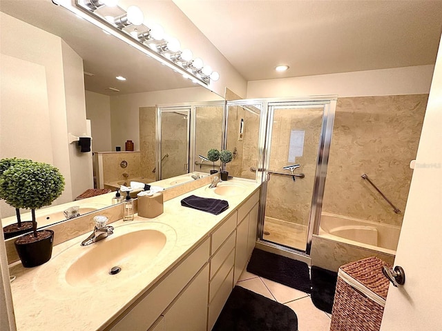 full bath with tile patterned flooring, a garden tub, a sink, and double vanity