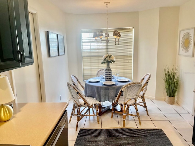 dining area with light tile patterned flooring, baseboards, and an inviting chandelier