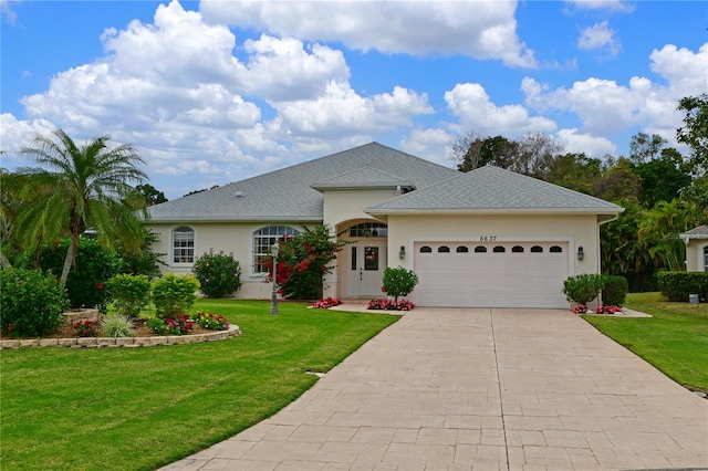 single story home with a front yard and a garage