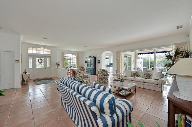 tiled living room featuring crown molding and plenty of natural light