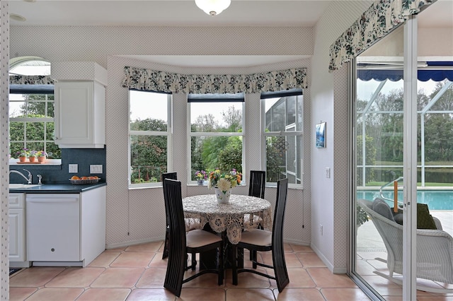 dining area featuring light tile patterned flooring and a wealth of natural light