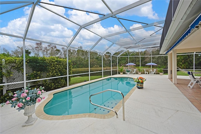 view of swimming pool with glass enclosure and a patio area