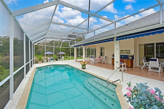 view of pool with a patio and glass enclosure