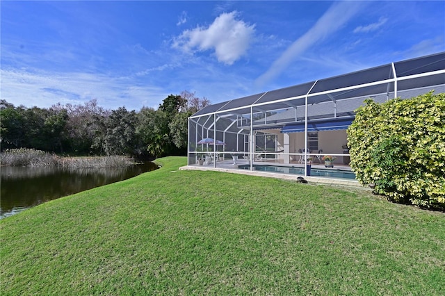 view of yard with a water view and glass enclosure