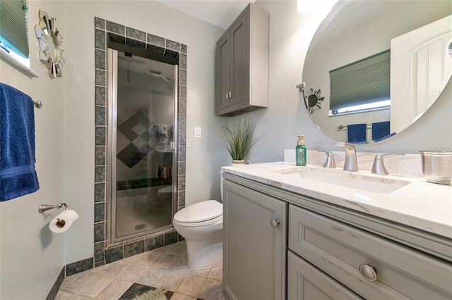 bathroom featuring walk in shower, vanity, and toilet