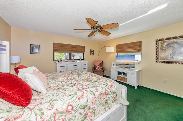 carpeted bedroom with ceiling fan and a textured ceiling