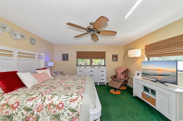 bedroom featuring ceiling fan, a textured ceiling, and dark colored carpet