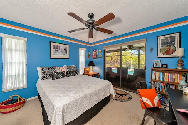 carpeted bedroom featuring ceiling fan and a textured ceiling