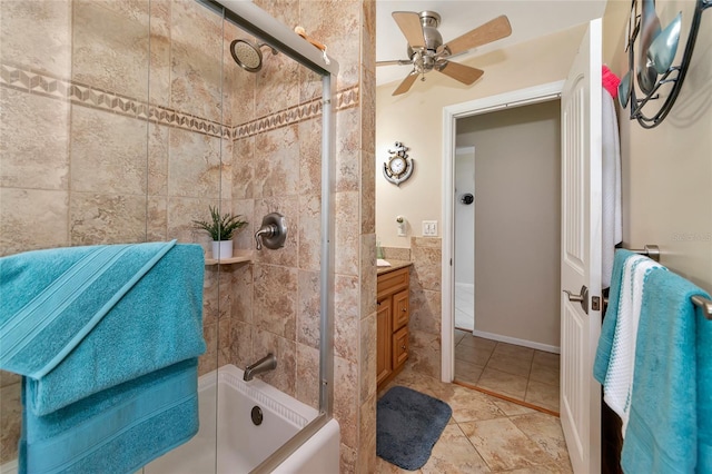 bathroom with ceiling fan, vanity, and tiled shower / bath