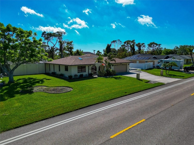 ranch-style home with a garage and a front yard