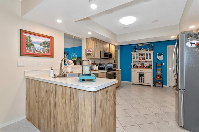 kitchen featuring kitchen peninsula, a textured ceiling, stainless steel appliances, sink, and light tile patterned flooring