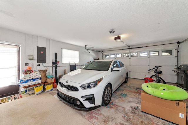 garage featuring a garage door opener and electric panel