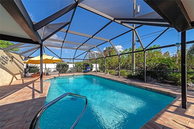 view of pool with a lanai and a patio area