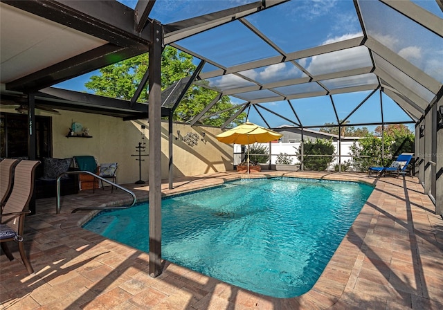 view of pool featuring a patio area and glass enclosure