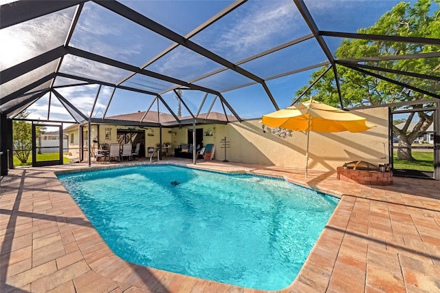 view of swimming pool with glass enclosure and a patio area