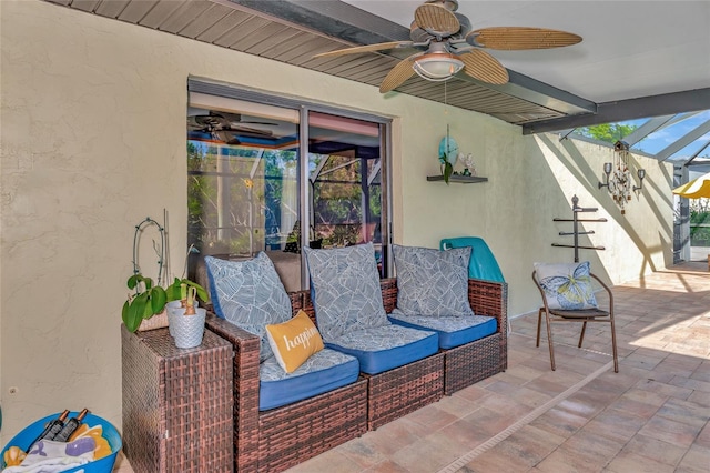 view of patio featuring glass enclosure and ceiling fan