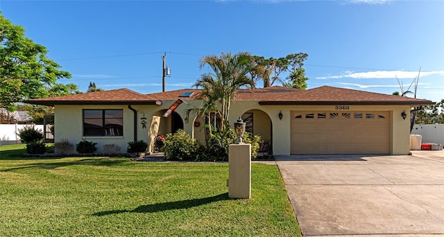 single story home featuring a garage and a front yard