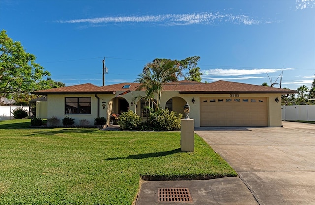 single story home featuring a garage and a front lawn