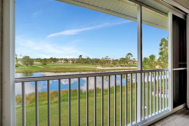 unfurnished sunroom featuring a water view