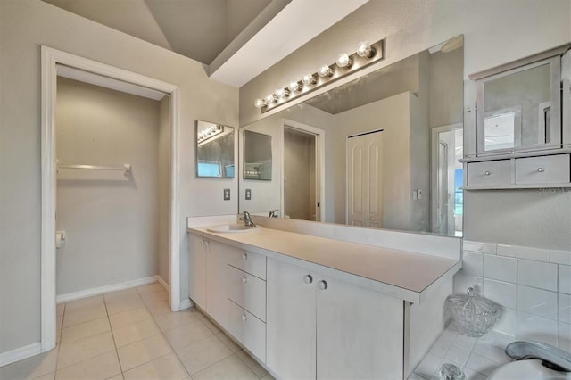 bathroom featuring lofted ceiling, vanity, and tile patterned flooring