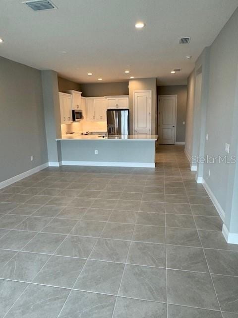 unfurnished living room featuring light tile patterned flooring