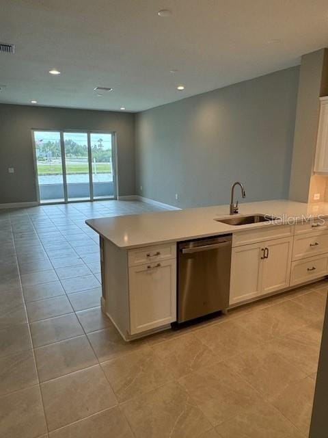 kitchen featuring white cabinetry, stainless steel dishwasher, sink, and light tile patterned floors