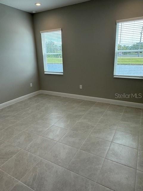 empty room with light tile patterned flooring