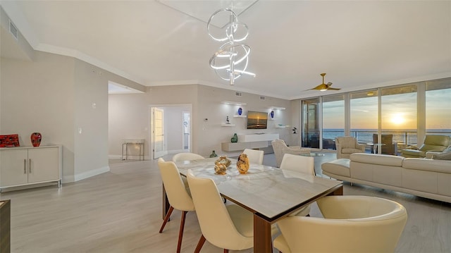 dining space featuring light hardwood / wood-style flooring and crown molding