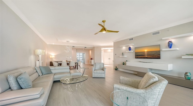 living room featuring ornamental molding and light hardwood / wood-style floors