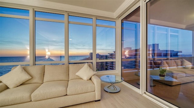 sunroom / solarium featuring a water view